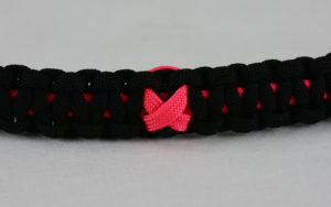 pink and black breast cancer support paracord bracelet with pink ribbon in the center