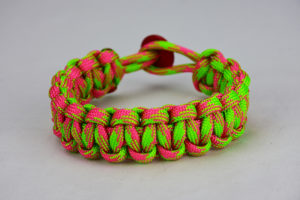 pink and neon green camouflage paracord bracelet unity band with red button, picture of a pink and neon green camouflage paracord bracelet unity band with red button fastener in the back on a white background