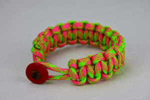 pink and neon green camouflage paracord bracelet unity band with red button in the front, picture of a pink and neon green paracord bracelet unity band with red button fastener in the front on a white background