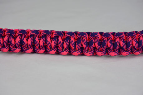 pink and purple camouflage paracord bracelet unity band across the center of a white background