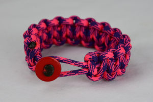 pink and purple camouflage paracord bracelet unity band with red button front, picture of a pink and purple camouflage paracord bracelet unity band with red button fastener on a white background