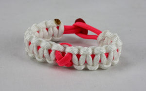 pink and white breast cancer support paracord bracelet with red button back and pink ribbon
