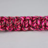 pink camouflage paracord bracelet unity band across the center of a white background