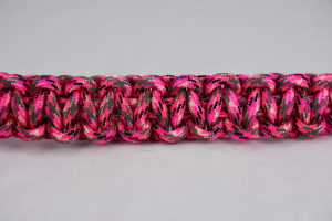 pink camouflage paracord bracelet unity band across the center of a white background