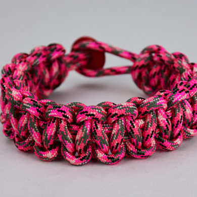 pink camouflage paracord bracelet unity band w red button in back, picture of a pink paracord bracelet unity band with red button fastener in the back
