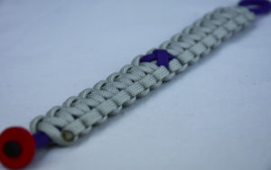 purple and grey alzheimers support paracord bracelet with red button corner and purple ribbon