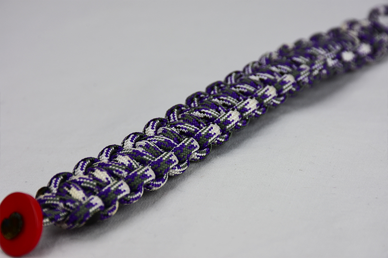 purple camouflage paracord bracelet unity band with red button in the corner, picture of a purple camouflage paracord bracelet unity band with red button fastener in the corner on a white background