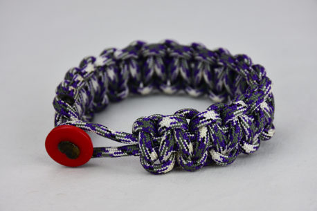 purple camouflage paracord bracelet unity band with red button front, picture of a purple camouflage paracord bracelet with red button fastener in the front on a white background