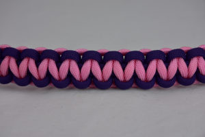 purple purple and soft pink paracord bracelet unity band going across the center of a white background