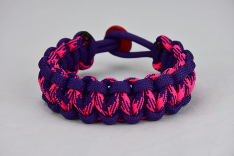 purple purple pink and purple camouflage paracord bracelet unity band with red button in the back, picture of a purple purple pink and purple camouflage paracord bracelet unity band with red button fastener in the back on a white background