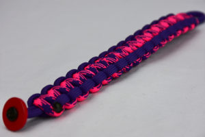 purple purple pink and purple camouflage paracord bracelet unity band with red button in corner, picture of a purple purple pink and purple camouflage paracord bracelet unity band with red button fastener in the bottom corner on a white background