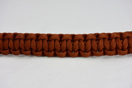rust paracord bracelet unity band across the center of a white background, rust paracord bracelet unity band