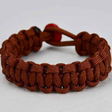 rust paracord bracelet unity band with red button, picture of a rust paracord bracelet unity band with a red button fastener on a white background
