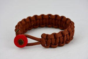 rust paracord bracelet with red button in the front, picture of a rust paracord bracelet unity band with red button fastener on a white background