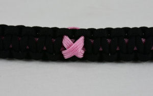soft pink and black breast cancer support paracord bracelet with soft pink ribbon in the center