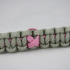 soft pink and grey breast cancer support paracord bracelet with a pink ribbon in the center, picture of a soft pink and grey breast cancer support paracord bracelet unity band with a pink ribbon in the center of the band