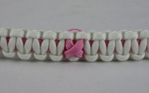 soft pink and white breast cancer support paracord bracelet with soft pink ribbon center