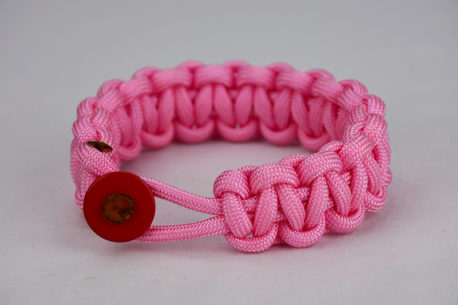soft pink paracord bracelet unity band with red button in front, picture of a soft pink paracord bracelet unity band with red button fastener in the front on a white background