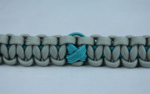 teal and grey ptsd support paracord bracelet with center teal ribbon