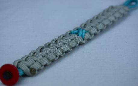 teal and grey ptsd support paracord bracelet with red button corner and teal ribbon