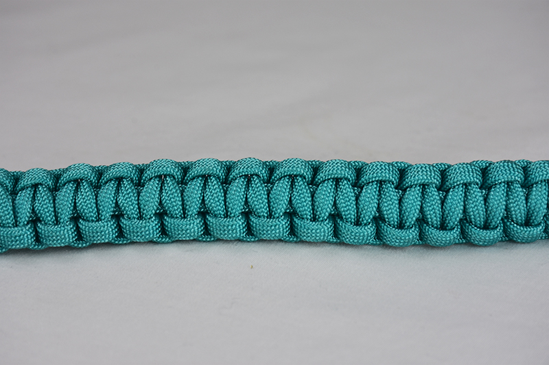 teal paracord bracelet unity band across the center of a white background