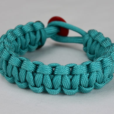 teal paracord bracelet unity band with red button in back, picture of a teal paracord bracelet unity band with red button fastener in the back on a white background