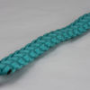 teal paracord bracelet unity band with red button in the front corner, picture of a teal paracord bracelet with red button fastener in the front corner on a white background