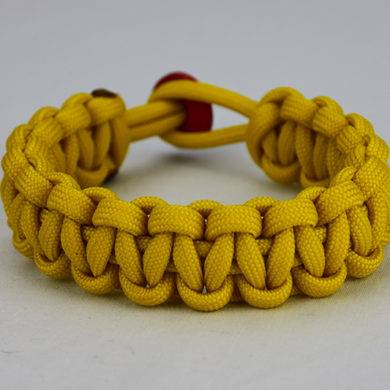 yellow paracord bracelet unity band with red button in back, picture of a yellow paracord bracelet unity band with red button fastener in the back on a white background