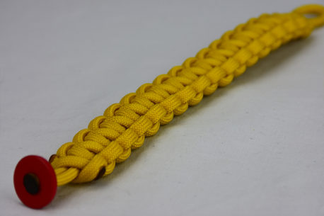 yellow paracord bracelet unity band with red button in corner, picture of a yellow paracord bracelet unity band with red button fastener in the bottom corner with white background