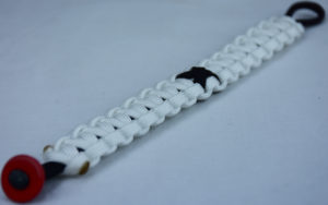 black and white pow mia support paracord bracelet with red button corner and black ribbon