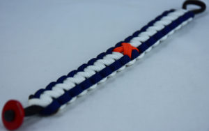 black navy blue and white leukemia support paracord bracelet with red button in the bottom corner and orange ribbon