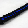 black paracord bracelet with blue line and red button in the corner