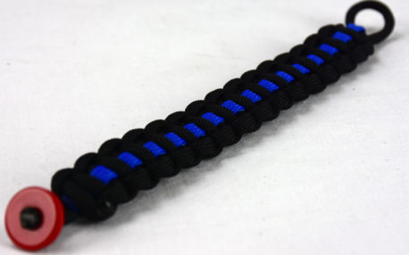 black paracord bracelet with blue line and red button in the corner