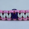 black soft pink and white alzheimers support paracord bracelet with purple ribbon in the center of a white background