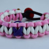 black soft pink and white alzheimers support paracord bracelet with red button in the back and purple ribbon