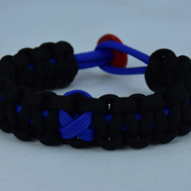 blue and black anti-bullying paracord bracelet with red button in the back and blue ribbon