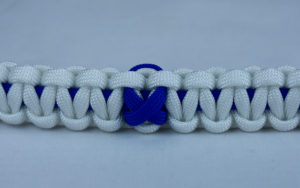 blue and white anti-bullying paracord bracelet with blue ribbon in the center