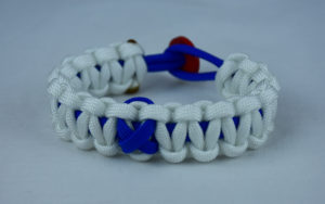 blue and white anti-bullying paracord bracelet with red button in the back and blue ribbon