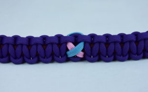 burgundy and purple sids support paracord bracelet with tarheel blue and pink ribbon in the center