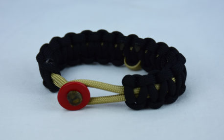 gold and black pediatric cancer support paracord bracelet with red button front and gold ribbon