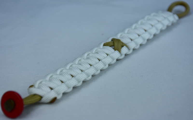 gold and white pediatric cancer support paracord bracelet with red button fastener in the front corner and gold ribbon