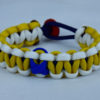 navy blue white and yellow anti bullying paracord bracelet with red button fastener in the back and blue ribbon