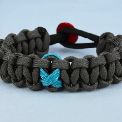 od green and tan ptsd support paracord bracelet with red button in back and teal ribbon