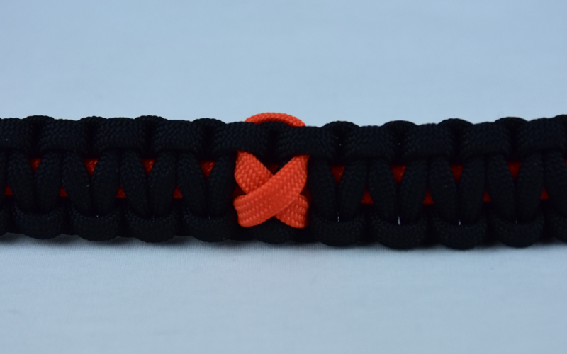 orange and black leukemia support paracord bracelet with orange ribbon in the center
