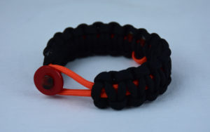 orange and black leukemia support paracord bracelet with red button front and orange ribbon