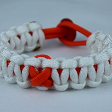 orange and white leukemia support paracord bracelet with red button in the back and orange ribbon
