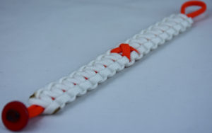 orange and white leukemia support paracord bracelet with red button in the bottom corner and orange ribbon