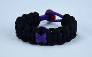 purple and black alzheimers support paracord bracelet with red button in the back and a purple ribbon
