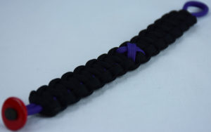 purple and black alzheimers support paracord bracelet with red button in the corner and a purple ribbon