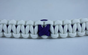 purple and white alzheimers support paracord bracelet with purple ribbon in the center of a white background
